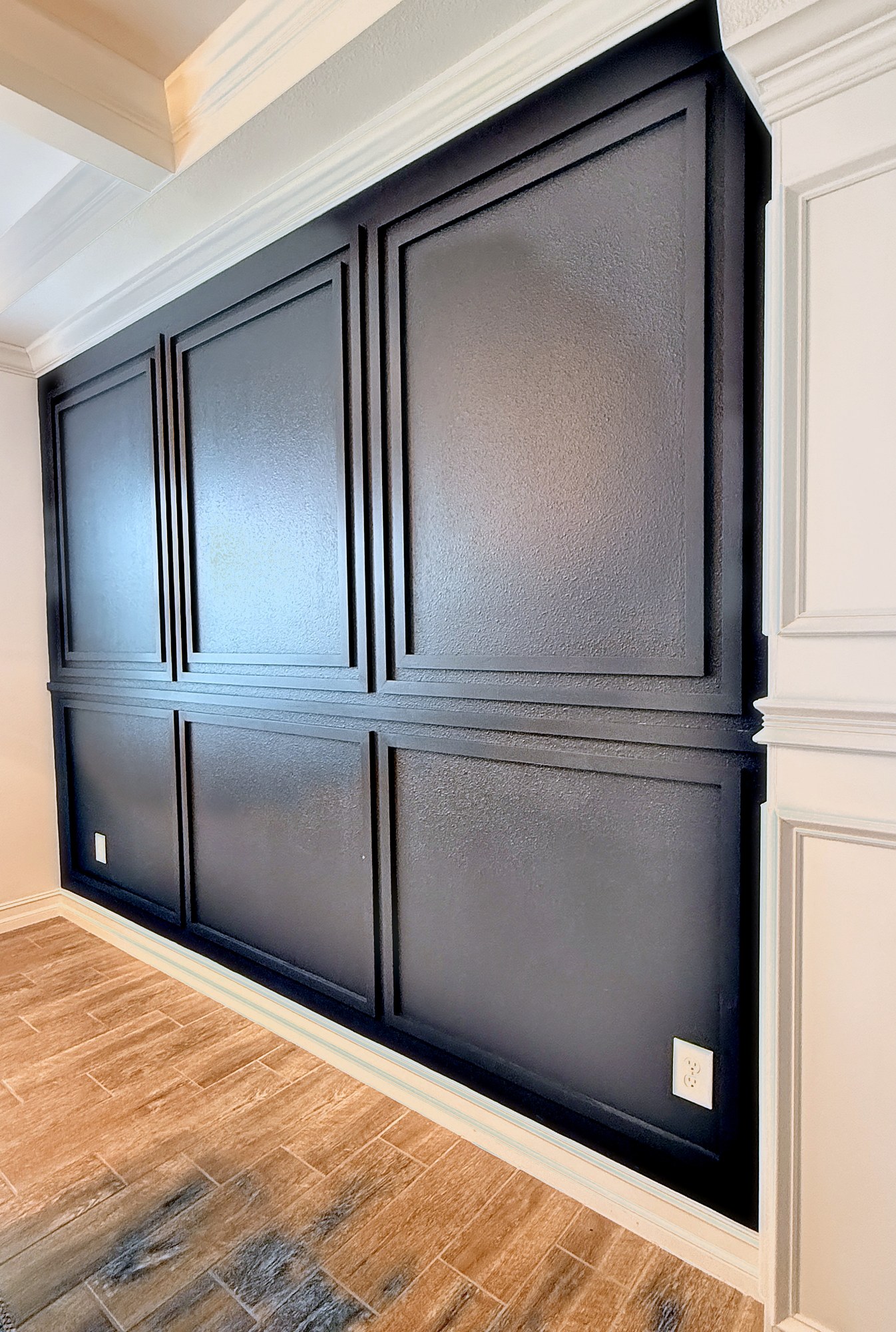 Black picture-frame moulding accent wall in a foyer