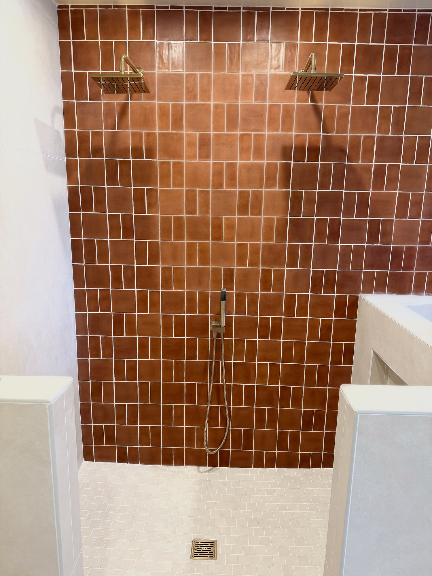 Finished terracotta-tile shower with dual rain shower heads