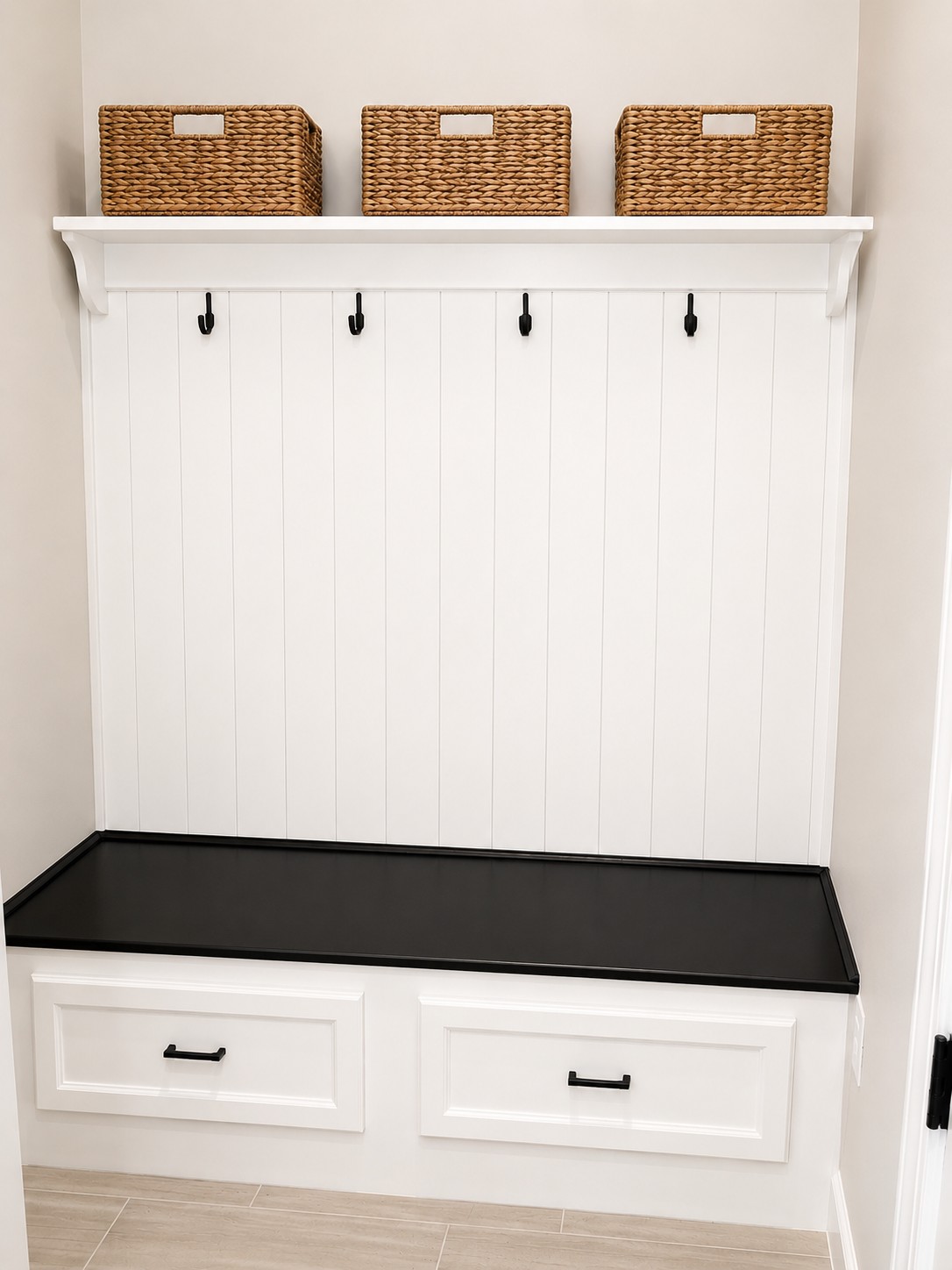Custom entryway built-in with open shelving, coat hooks, and a drawer bench
