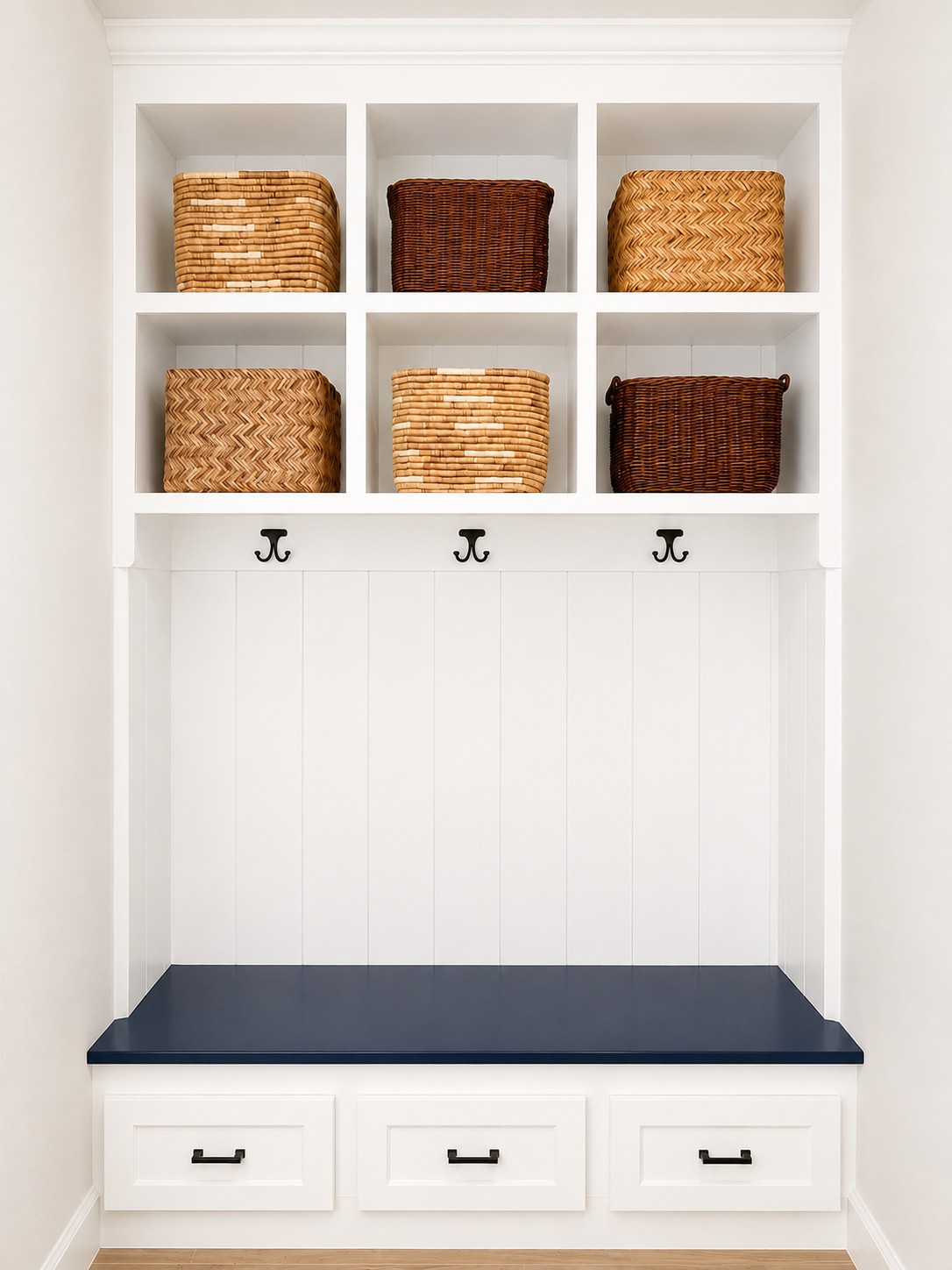 Custom entryway built-in with cubby storage, coat hooks, and a drawer bench