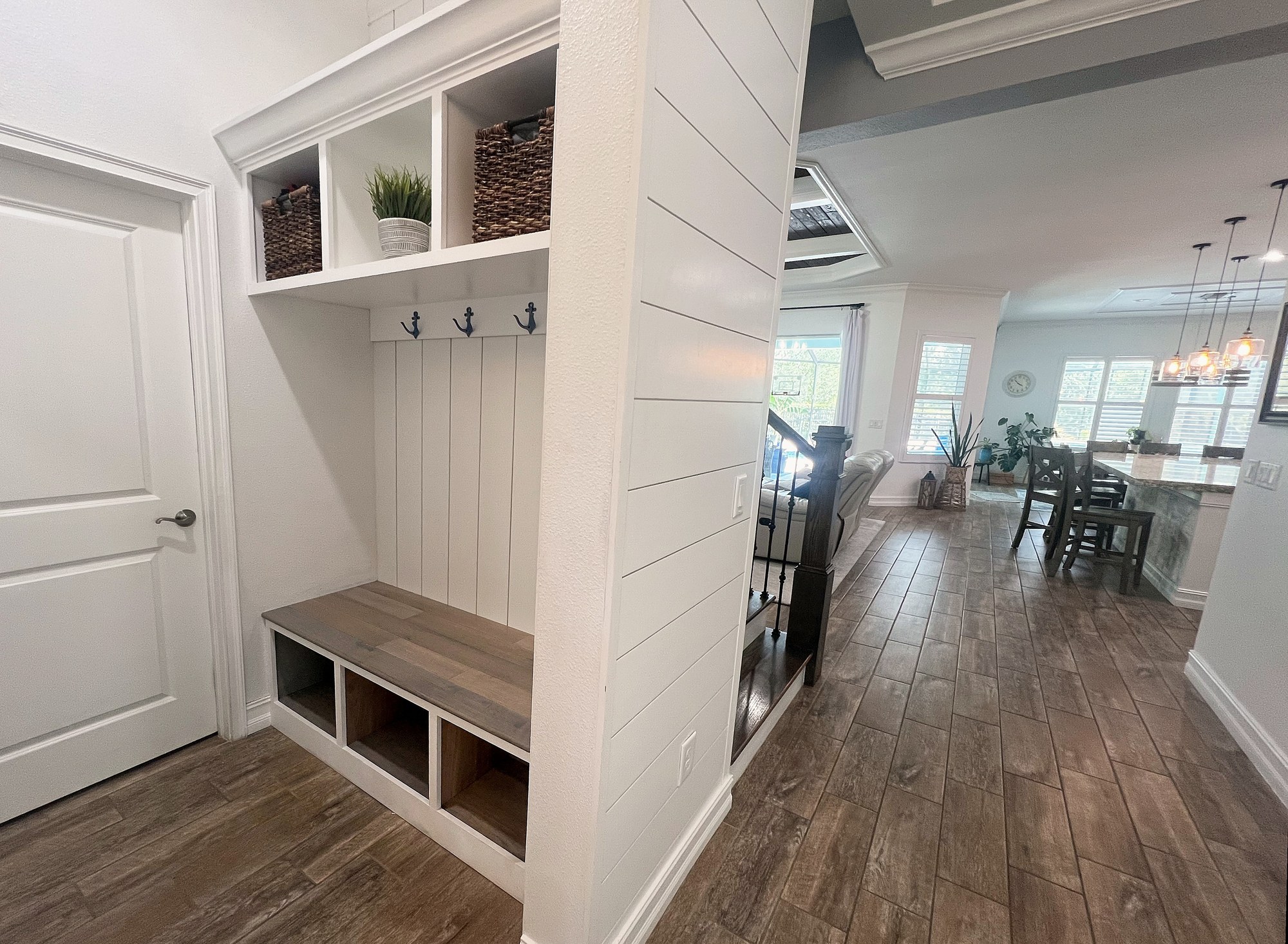 Custom mudroom bench with cubbies and shiplap built-ins