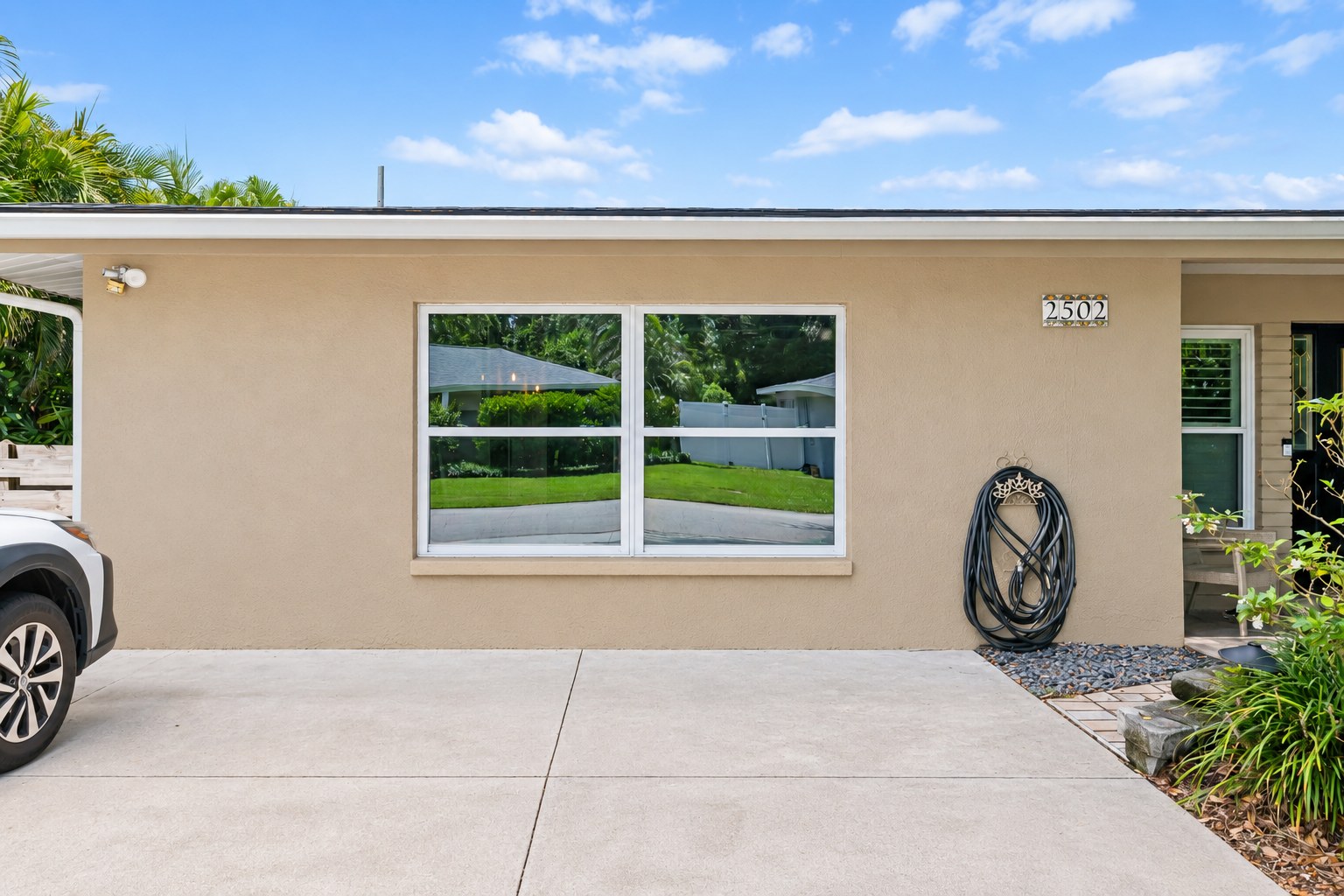 Finished exterior showing the former garage door replaced with a window wall