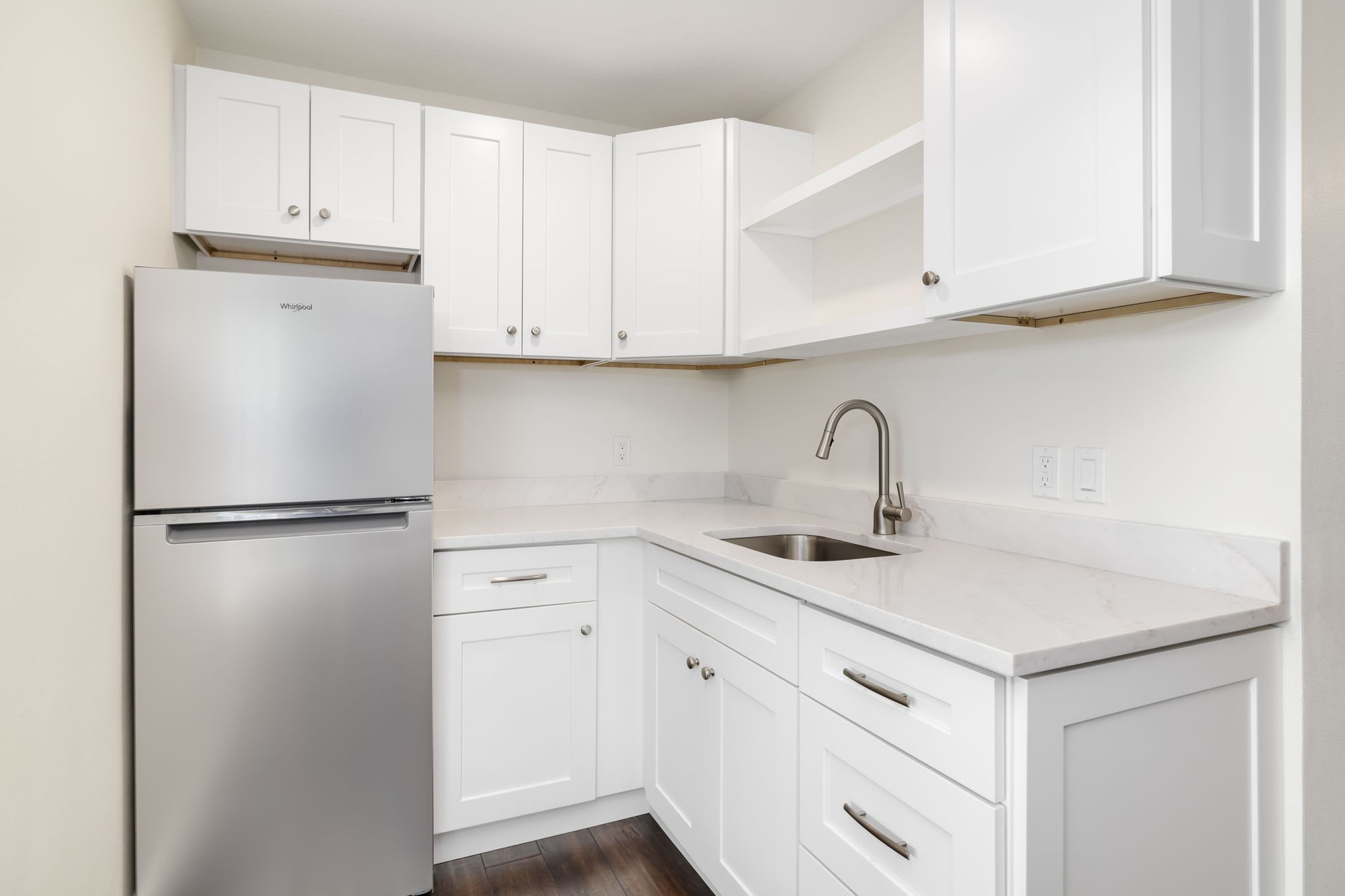 Finished garage conversion kitchenette with white cabinetry