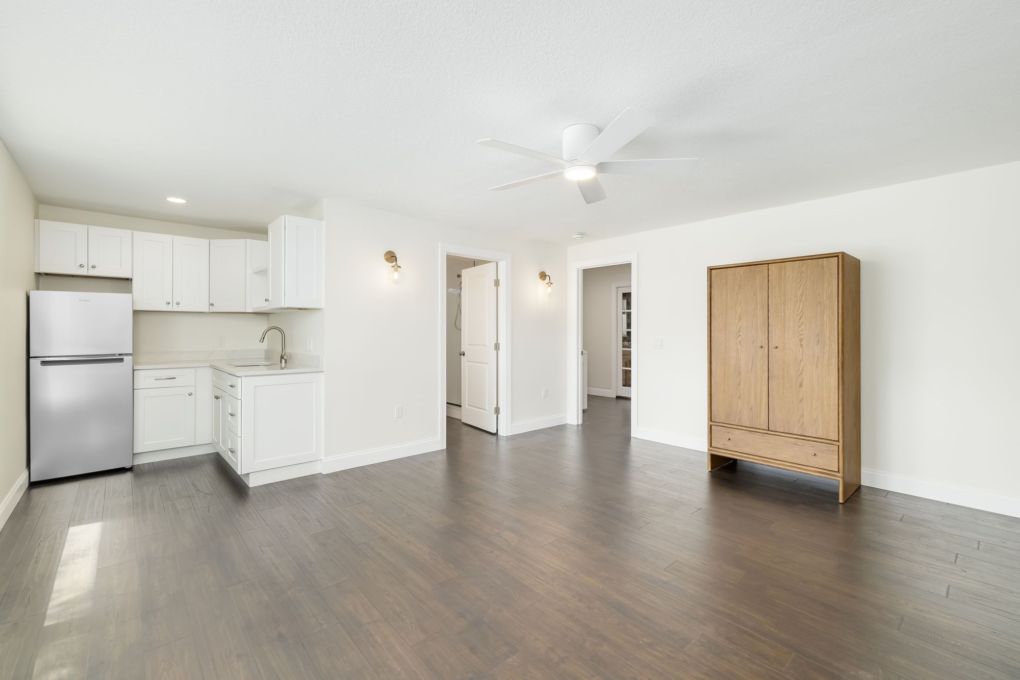 Finished garage conversion living space with wood-look flooring, Sarasota, FL