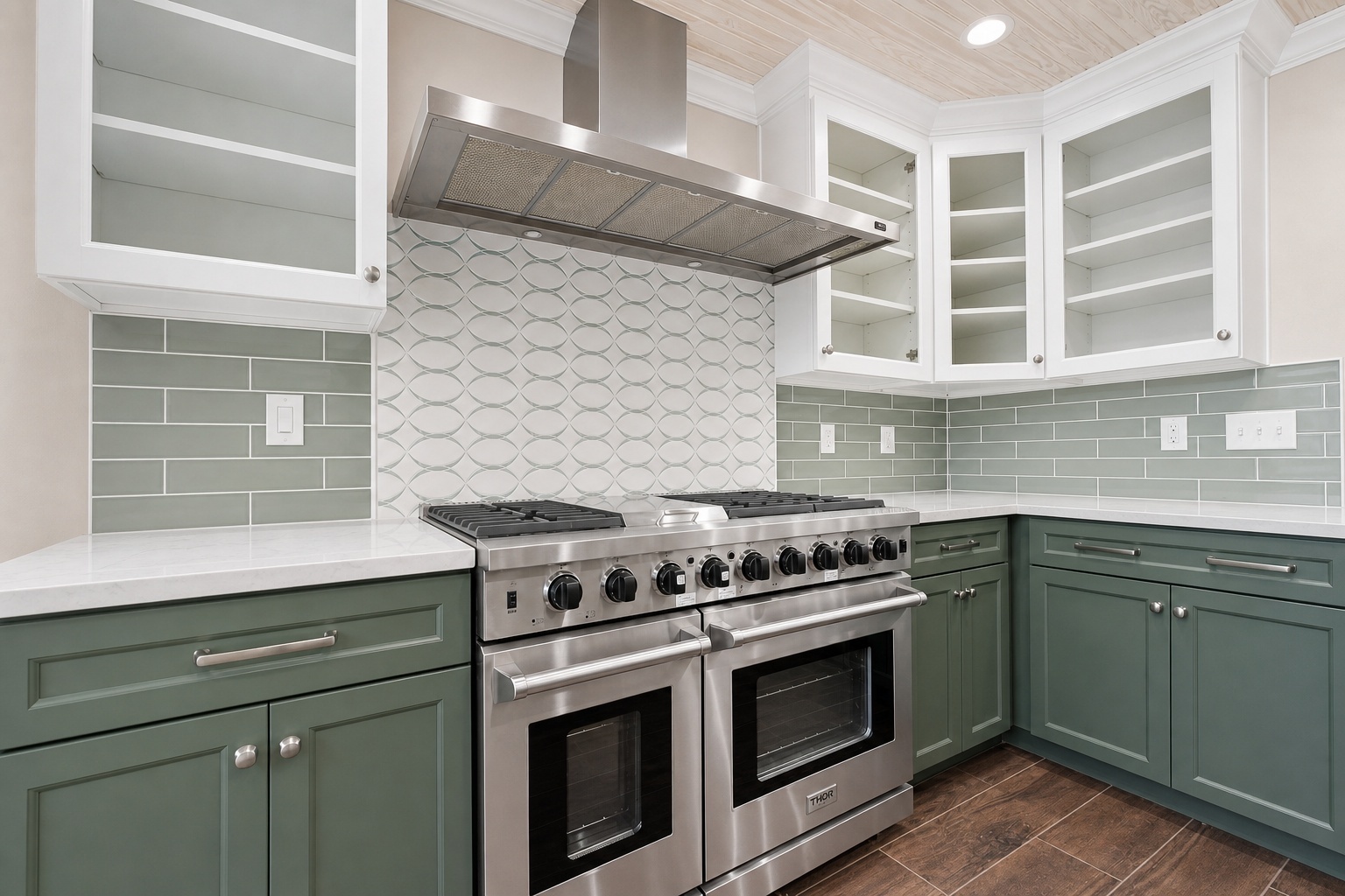 Finished kitchen remodel with sage green cabinetry and a professional range