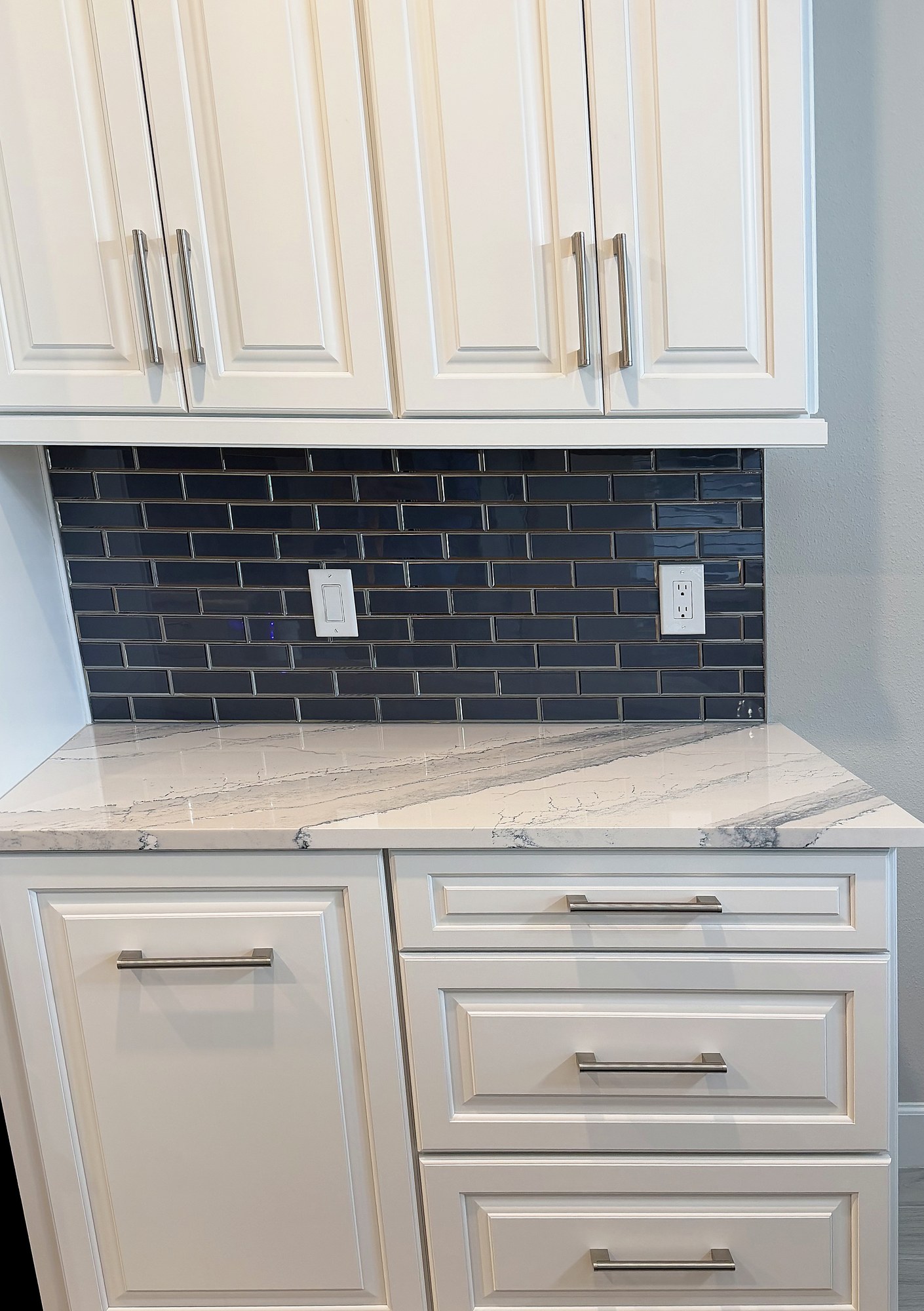 Finished coffee bar with navy subway tile and beverage fridge