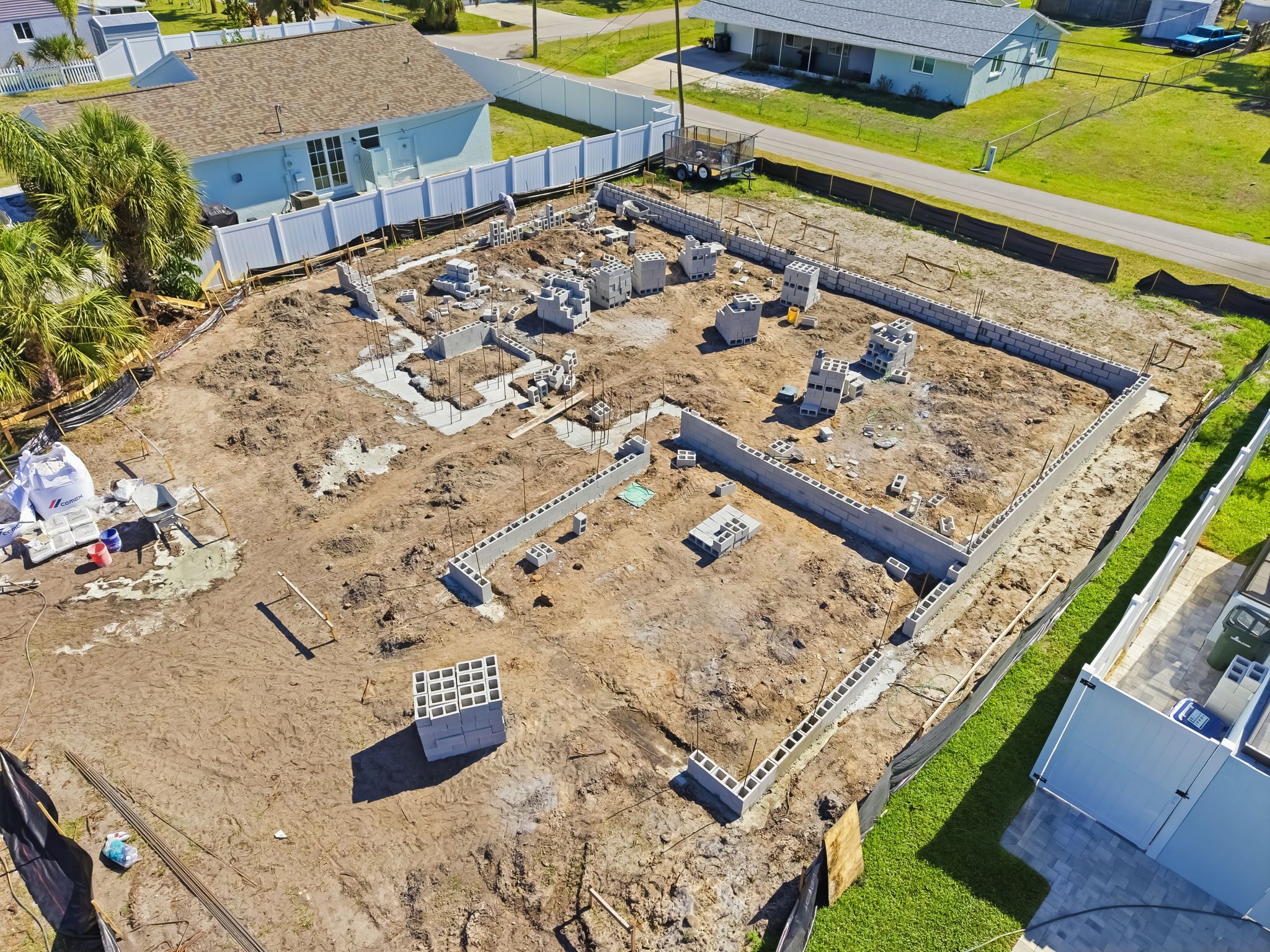 Aerial view of a new home's foundation and block work underway