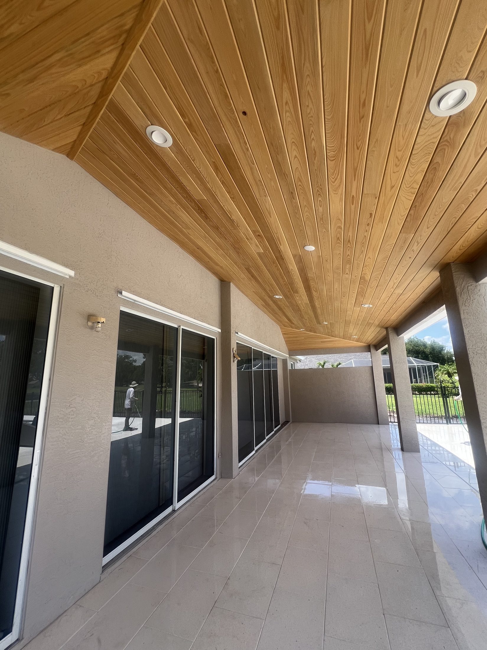 Covered lanai walkway with wood-clad vaulted ceiling