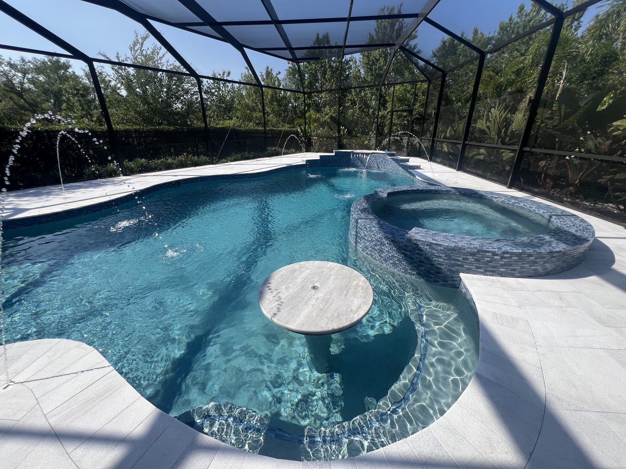 Screened pool and spa with deck jets running