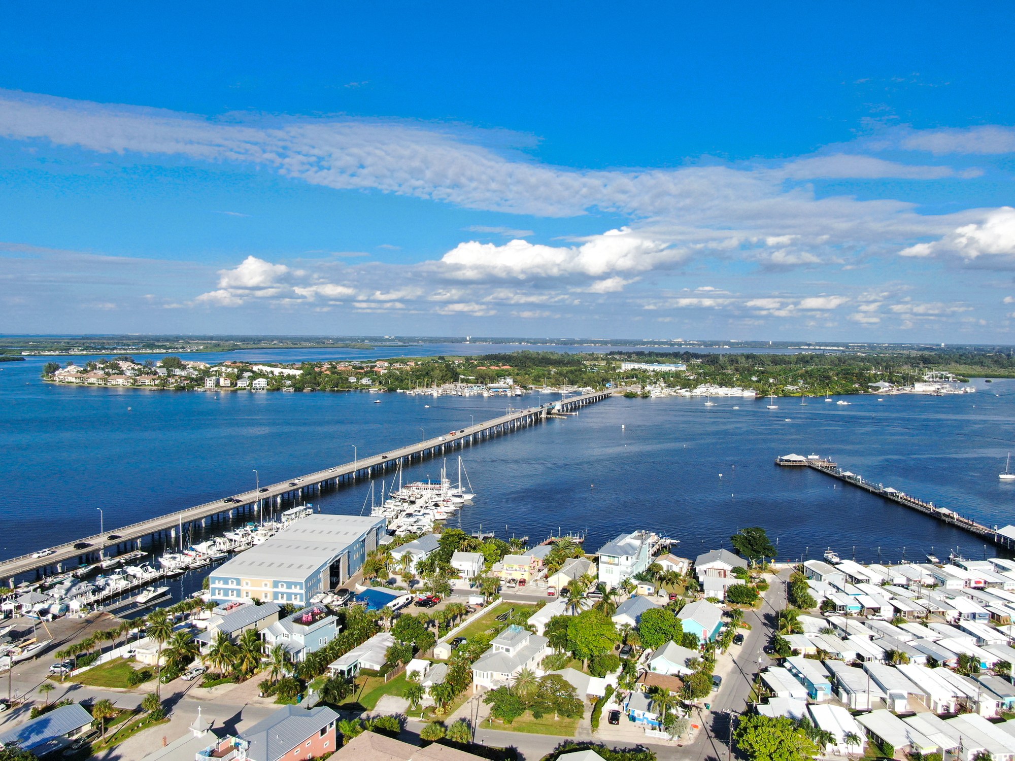 Aerial view of a Manatee County waterway with a causeway bridge and waterfront homes