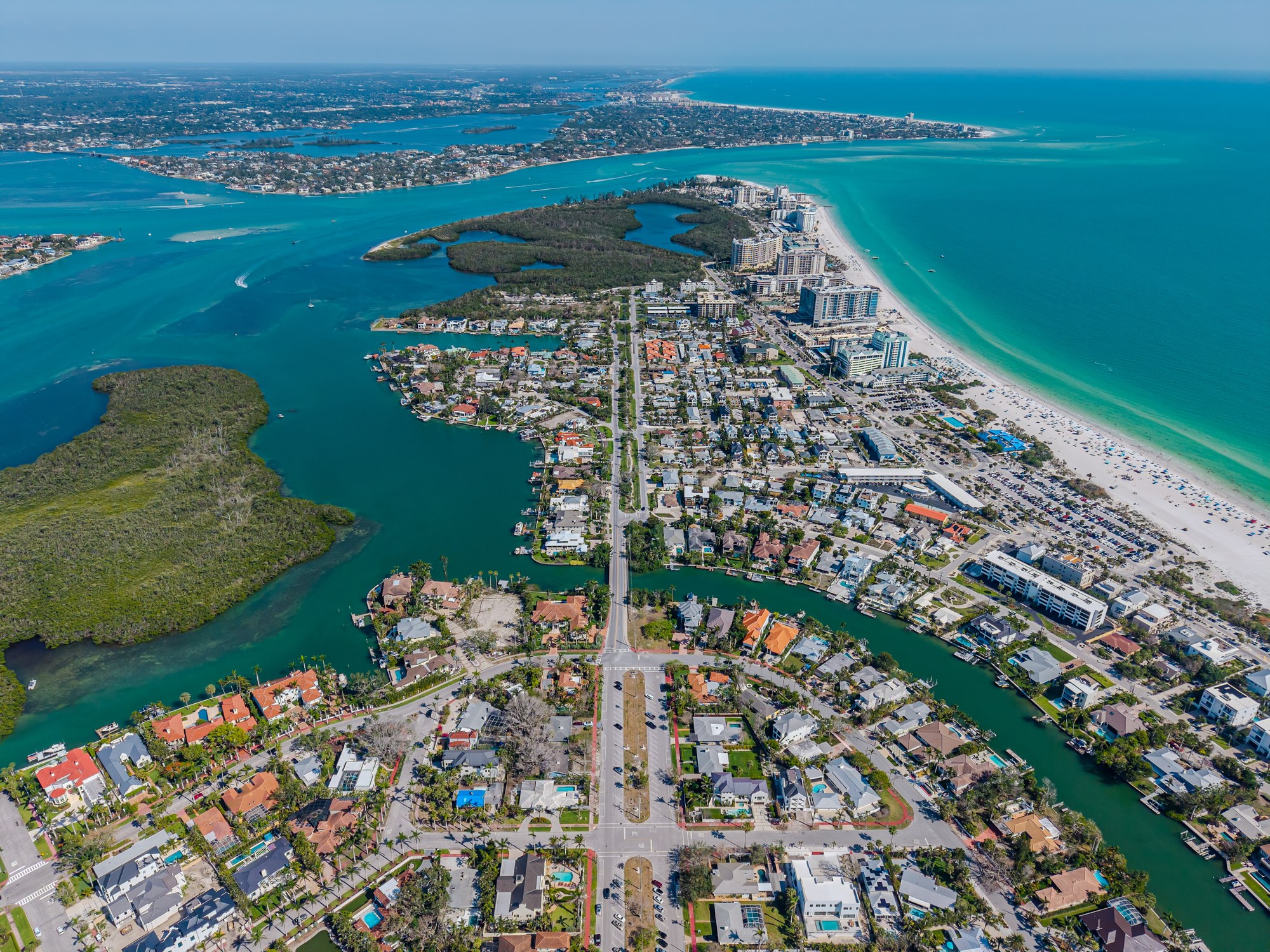 Aerial view of Sarasota's coastline, barrier islands, and waterfront neighborhoods