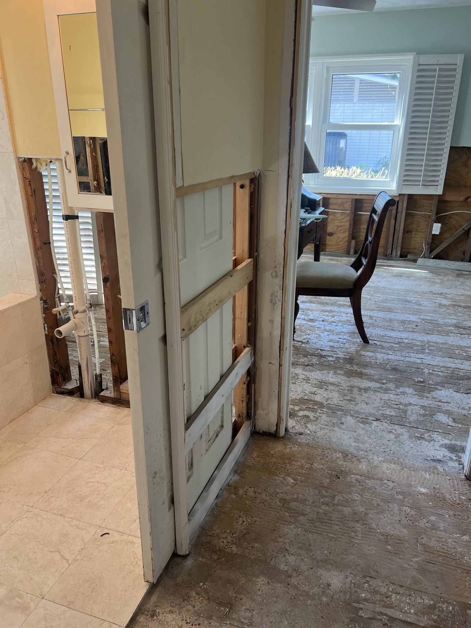 Flood-cut drywall and exposed framing during storm damage stabilization, Florida