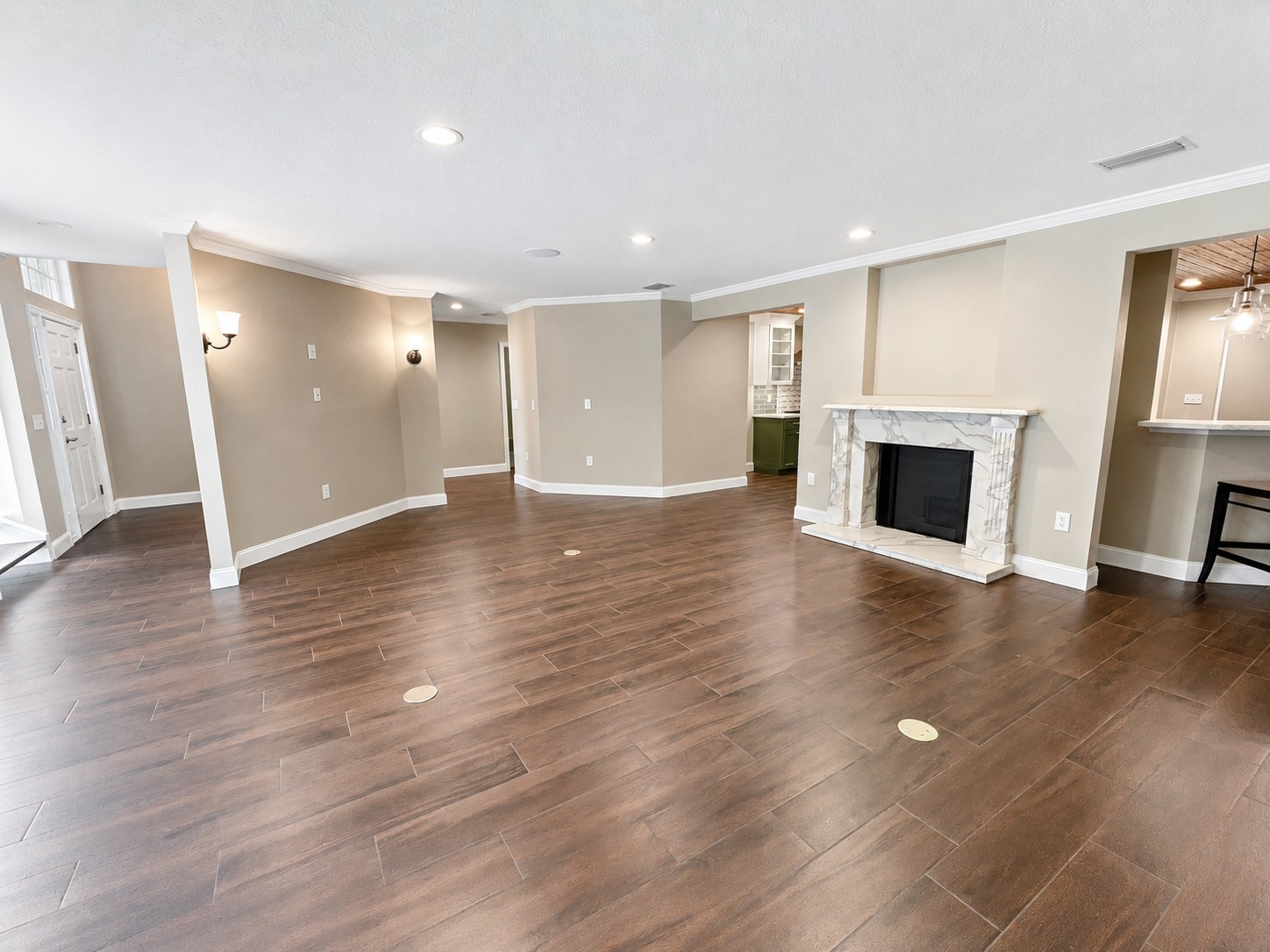 Finished great room with marble fireplace surround after a whole-home remodel
